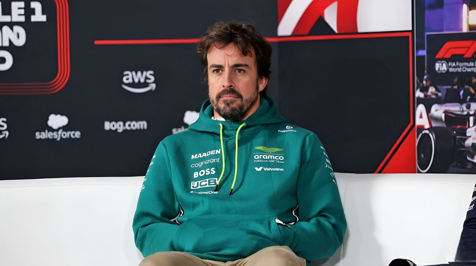 Fernando Alonso wearing an Aston Martin F1 team hoodie during a 2026 media interview discussing his racing future and retirement plans.