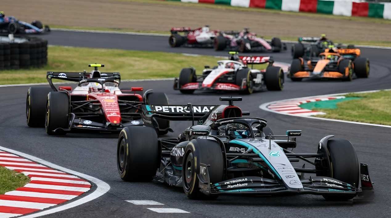 Mercedes F1 car leads Ferrari SF-26 through a corner at Suzuka Circuit 2026, showing Ferrari cornering grip vs Mercedes straight-line speed