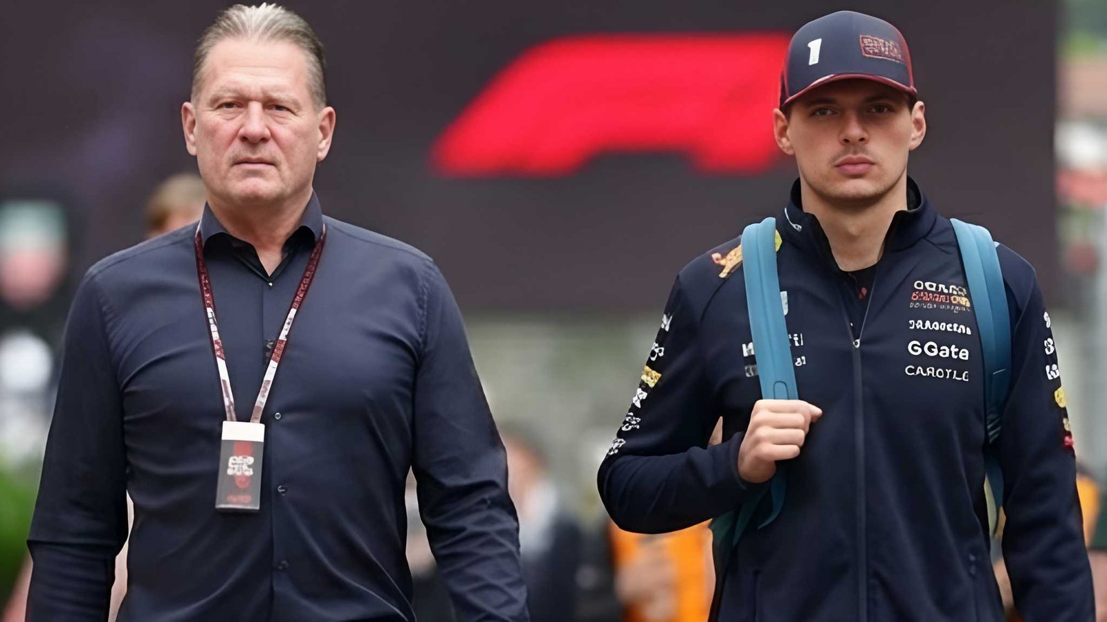 Jos Verstappen and Max Verstappen walking in the Red Bull F1 paddock during the 2026 season amid Helmut Marko leadership debate