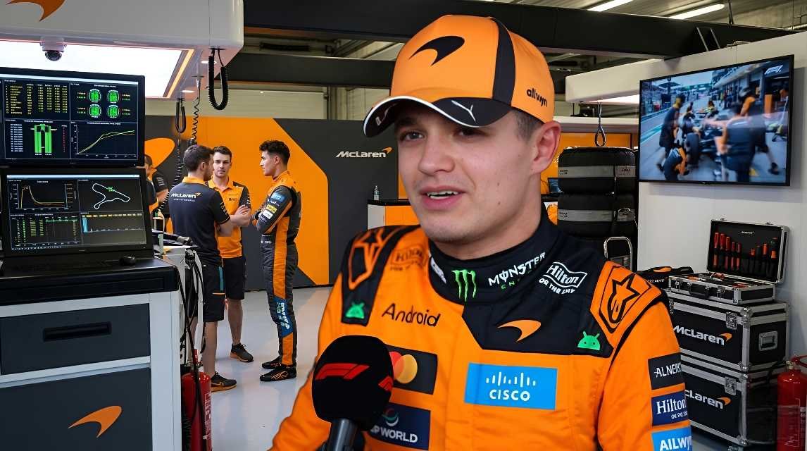 Lando Norris in McLaren race suit and cap speaks to F1 TV in the team garage during the 2026 Japanese Grand Prix weekend