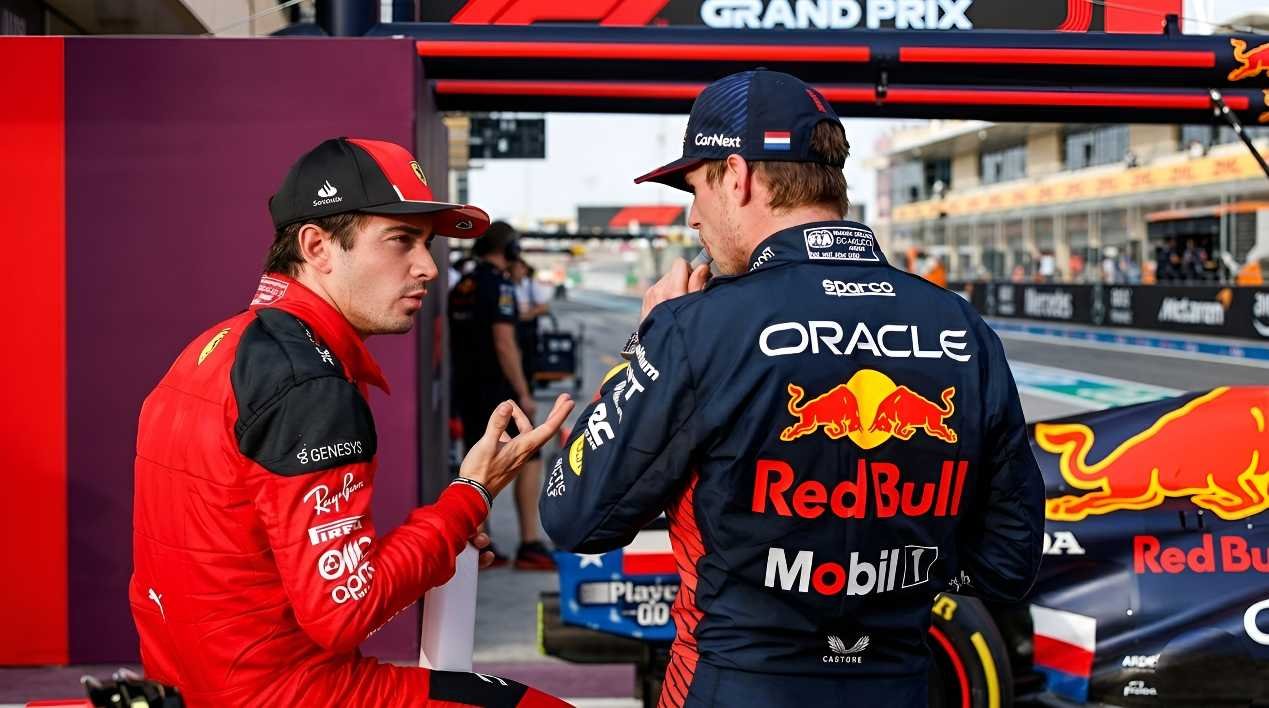 Max Verstappen of Red Bull Racing speaks with Ferrari driver Charles Leclerc in the F1 paddock during the 2026 season
